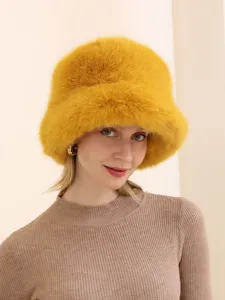 Close-up detail of stylish yellow fox fur winter bucket hat, warm plush texture for women.