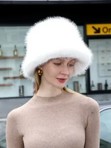 Close-up of the fluffy white plush bucket hat, showcasing cozy winter texture and soft warmth.