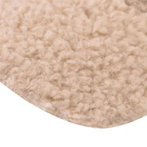 Close-up detail of thickened sherpa fleece fabric, soft and warm texture for winter caps.