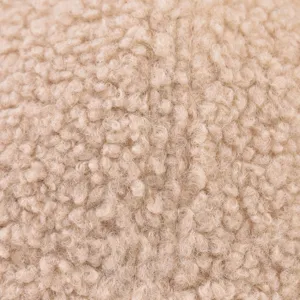 Close-up detail shot of thick lamb wool fabric texture in beige color, soft and warm feel.