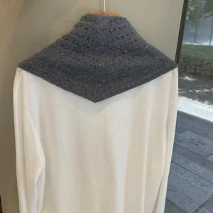 Grey knitted triangular scarf for women, hollow design winter wool shawl, versatile daily wear.
