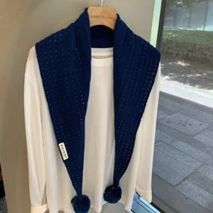 Stylish dark blue knitted triangular scarf with hollow design and cute pom-poms for autumn winter.