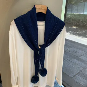 Dark blue knitted triangular scarf with hollow out texture and cute pompom pendants.