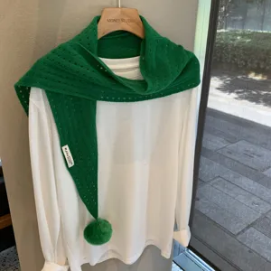 Green knitted hollow out triangle scarf with cute pom pom detail, stylish woolen accessory.