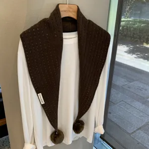 Brown knitted hollow triangle scarf with pom poms for women, autumn winter warm shawl detail.