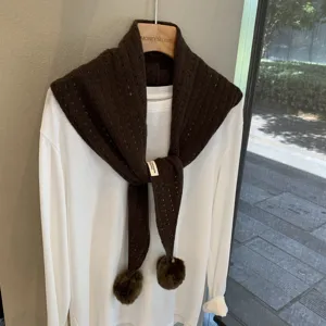Women winter dark brown knit triangular scarf with cute pom-poms and stylish hollow design.