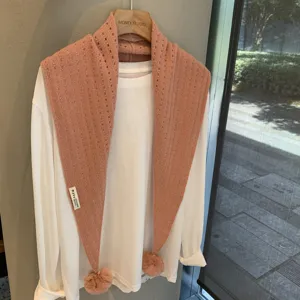 Pink knit triangular scarf with pom-poms, hollow wool shawl for women stylish autumn winter wear.
