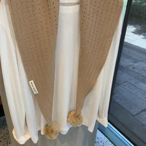Camel knit triangle scarf with pom poms, soft wool blend, stylish winter accessory shawl.
