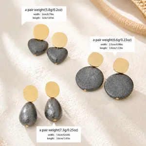 Detailed view of textured grey and gold earrings showing dimensions and pair weight clearly.
