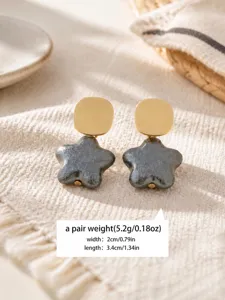 Grey textured star drop earrings with gold disc top, vintage elegant fashion jewelry for women.