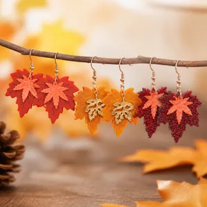 Close-up detail of double-layer autumn maple leaf earrings, retro color-blocking drop design.