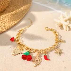Summer beach multi-charm gold bracelet with cute starfish and cherry pendants for vacation.