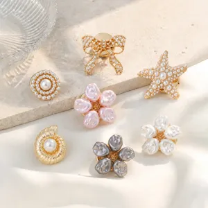 Detailed view of assorted French pearl buttons and pins, featuring bow, starfish, and flower designs.