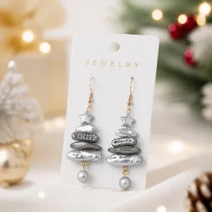 Close-up details of Christmas tree faux pearl earrings showcasing unique star pendants.