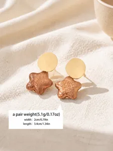 Elegant vintage textured star drop earrings for women, chic gold and bronze jewelry detail.