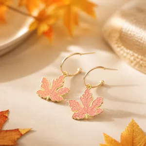 Autumn vibe maple leaf drop earrings with retro gold rim enamel pendant jewelry detail view.