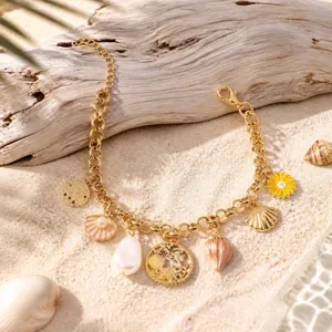 Exquisite summer ocean charm bracelet detail featuring delicate shell and star pendants.