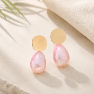 Close-up of pink pearl teardrop geometric earrings detail, elegant design for daily wear.