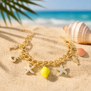 Summer beach gold charm bracelet with cute starfish and lemon pendants for vacation style.