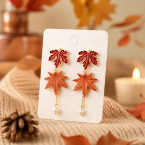 Autumn maple leaf pearl tassel earrings, delicate dangle design for seasonal chic fashion.