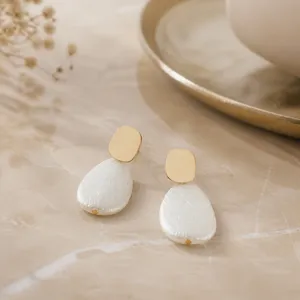 French vintage style gold metal and white textured faux pearl teardrop earrings detail close up view.