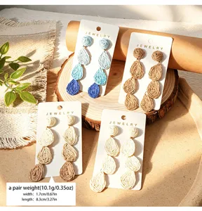Bohemian raffia teardrop dangle earrings, gradient blue and natural straw woven handmade jewelry.