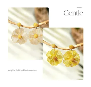 Elegant hollow metal flower earrings, bohemian vacation style line petal design for chic outfits.