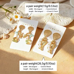 Boucles d'oreilles pendantes coquillage et étoile de mer style océan tropical.