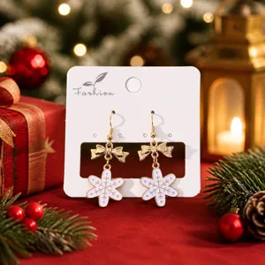 Boucles d'oreilles flocon de neige nœud de Noël, bijoux de fête dorés élégants pour femmes.