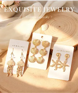 Boucles d'oreilles pendantes coquillage et etoile de mer dorees, style plage.