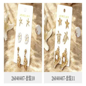 Ensemble boucles d'oreilles étoile de mer tortue coquillage style plage vacances détail.