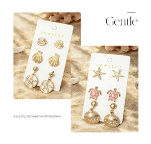 Ensemble de boucles d'oreilles de style plage océan avec des motifs de tortue et d'étoile.