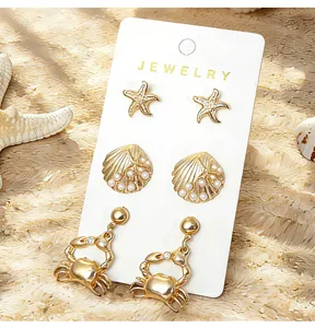 Ensemble de boucles d'oreilles style marin dore avec etoile de mer coquillage.