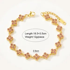 Detailed shot of gold stainless steel pink crystal four leaf clover charm bracelet jewelry.