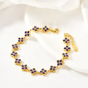 Blue stone clover detail of the gold bracelet, elegant jewelry accessory showcase view.