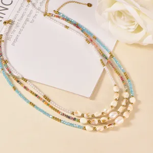 Handmade layered necklace detail featuring freshwater pearls and colorful glass beads elegantly.