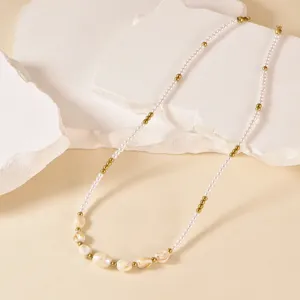 Elegant pearl and gold bead necklace featuring natural shell charms for stylish everyday wear.