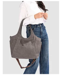 Detailed view of a vintage canvas tote bag with large capacity, casual style, and shoulder strap.
