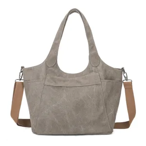Vintage canvas tote bag with brown straps, casual large capacity shoulder handbag.