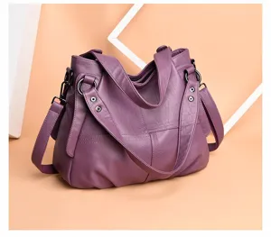 Detailed view of the purple PU leather women shoulder bag hardware and soft leather texture.