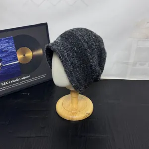 Cozy dark grey slouchy knit beanie, thick textured fabric detail for winter warmth and style.