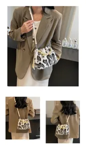 Close-up detail view of a chic leopard print plush shoulder bag featuring a pearl handle.