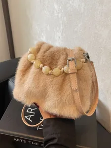 Fluffy plush bucket bag for women, soft faux fur crossbody handbag with elegant bead handle.