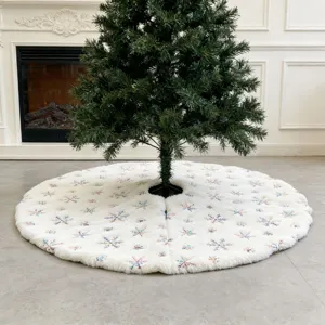 White plush Christmas tree skirt featuring colorful embroidered snowflake patterns for holiday home decor.
