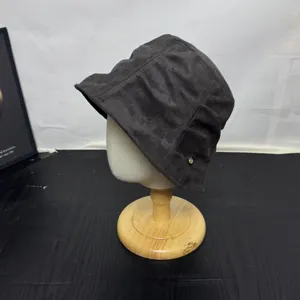 Detailed view of the Korean retro pleated bucket hat in dark grey with metal logo accent.