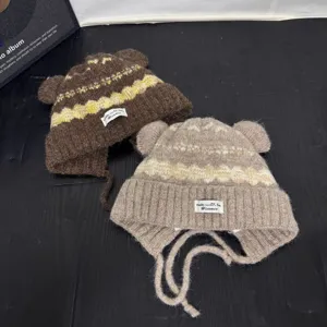 Detail view of the Fair Isle cute bear ear knitted hat with warm earflaps for winter.