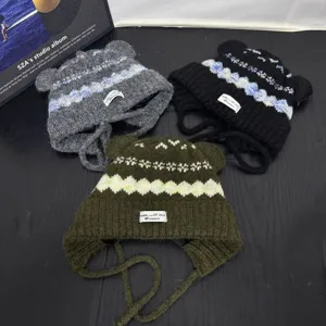 Detailed close-up view of knit bear ear hats with retro patterns and cute warm ear flaps.