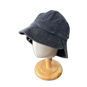 Vintage washed black denim bucket hat with stylish curved brim and side button detail main view