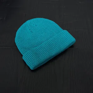 Turquoise knitted beanie for men and women, stylish winter cuffed skull cap streetwear.