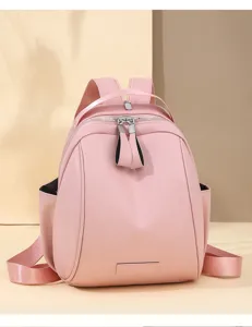 Pink dome backpack featuring durable dual zippers, adjustable straps, and clean minimalist detail.